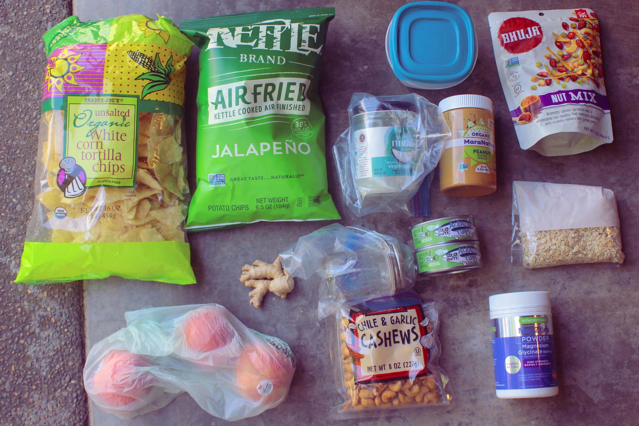 Snack food items to pack for Burning Man laid out on the ground.