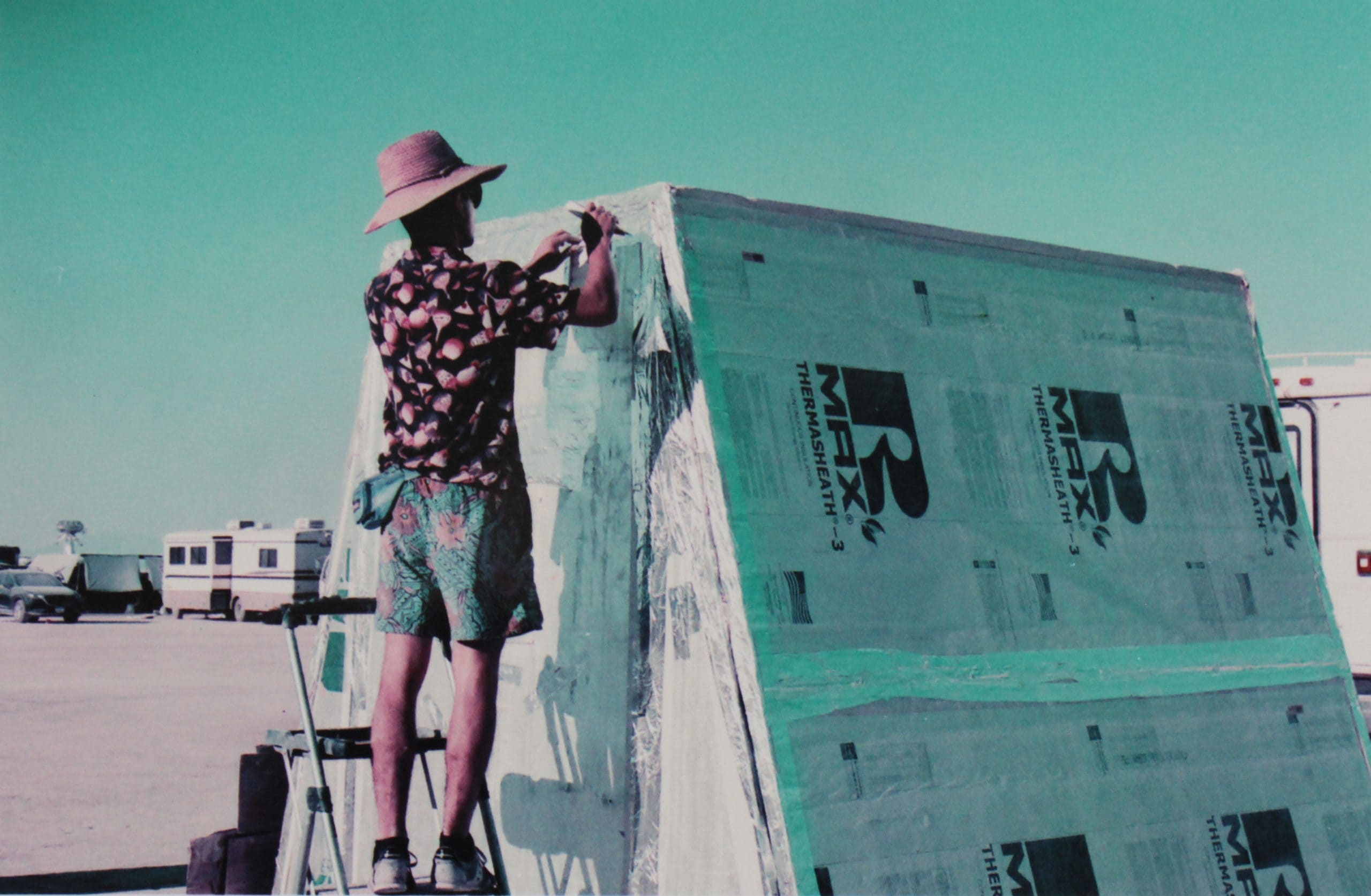 Man at Burning Man setting up his yurt shelter.