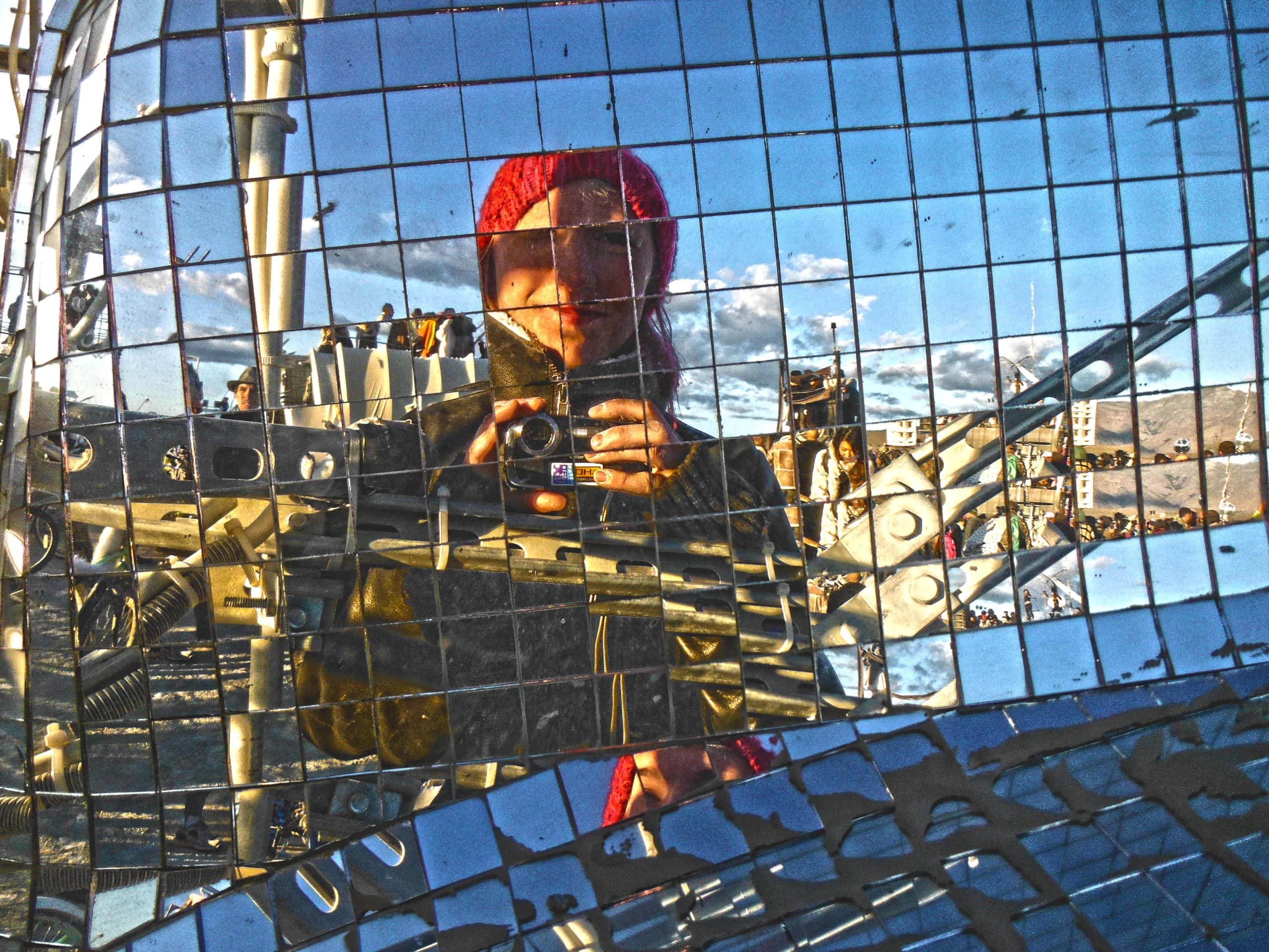 Taking a photo of my reflection on a giant disco ball-like glass mirror installation.
