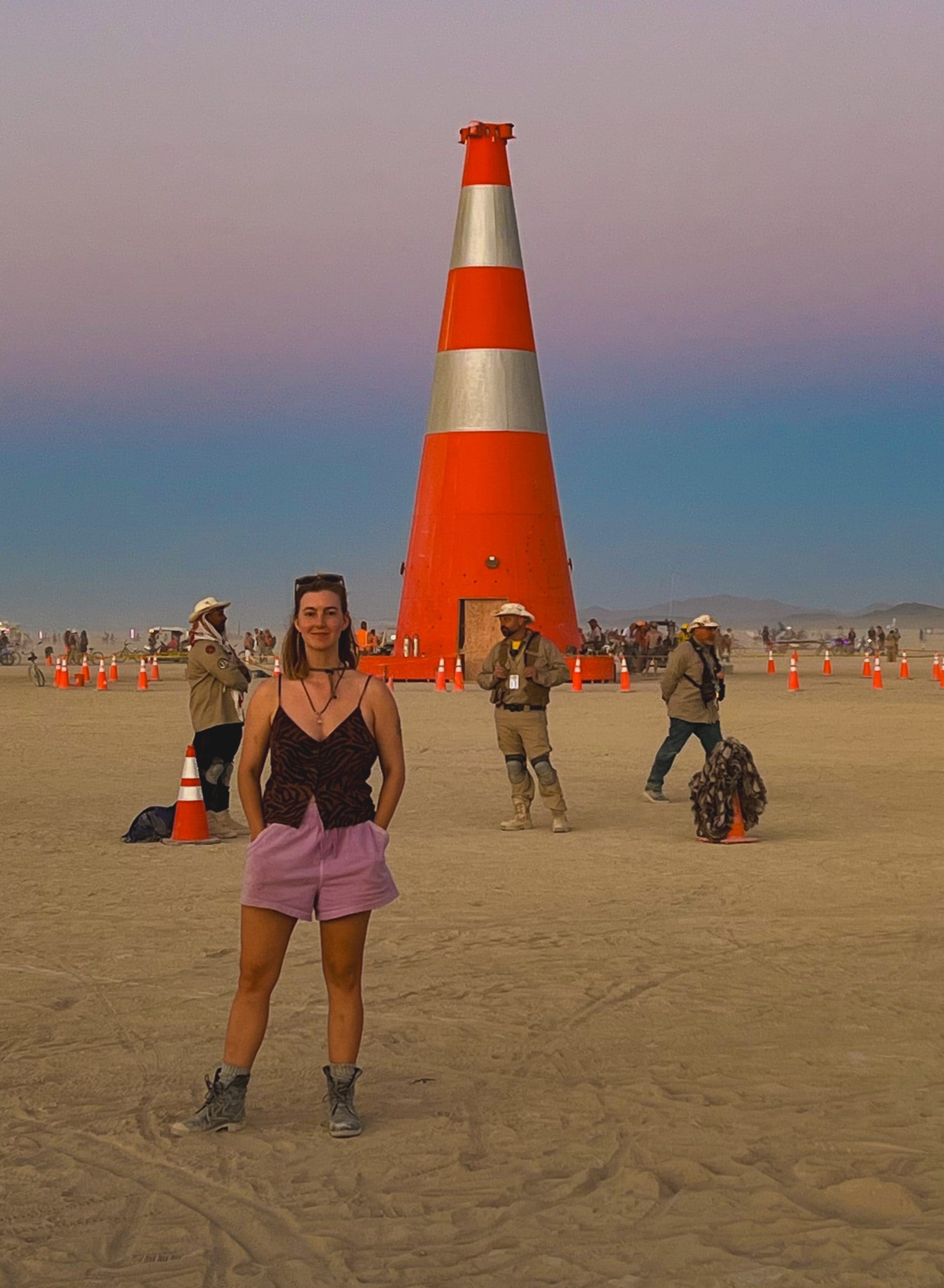 Wearing a simple versatile outfit on the playa in front of the giant traffic cone art installation.