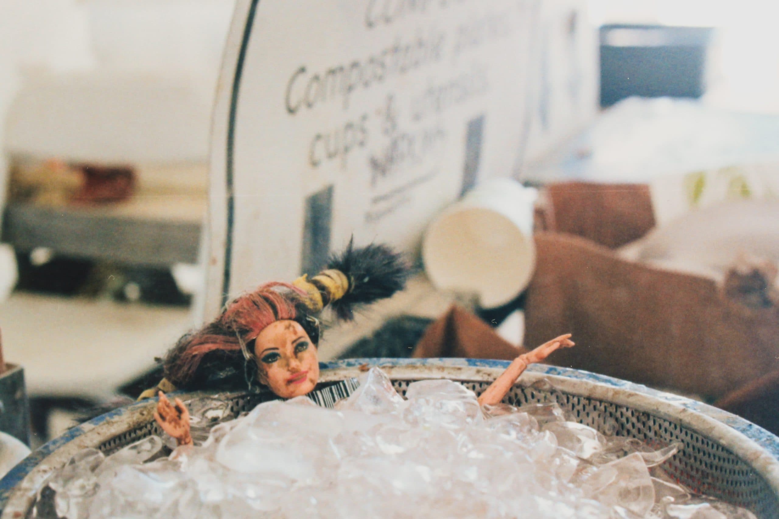 A Barbie in an ice bath in a small bowl.