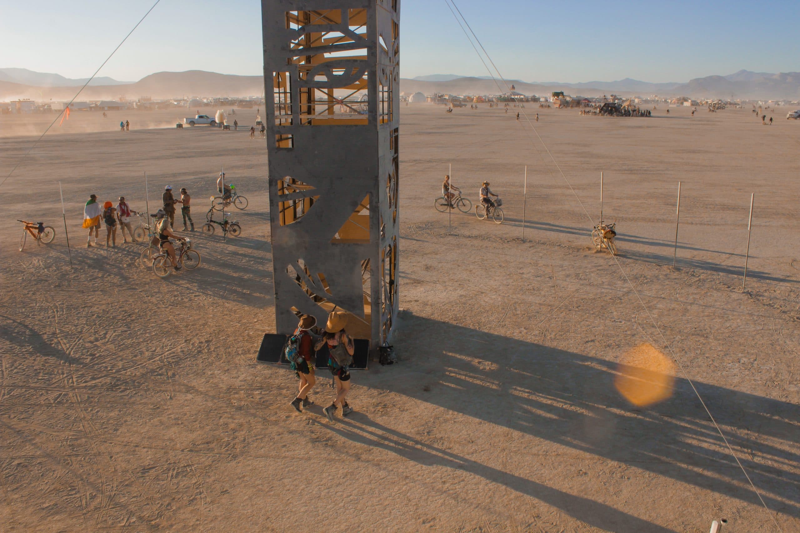 Large wooden pillar-like structure in the desert at Burning Man.